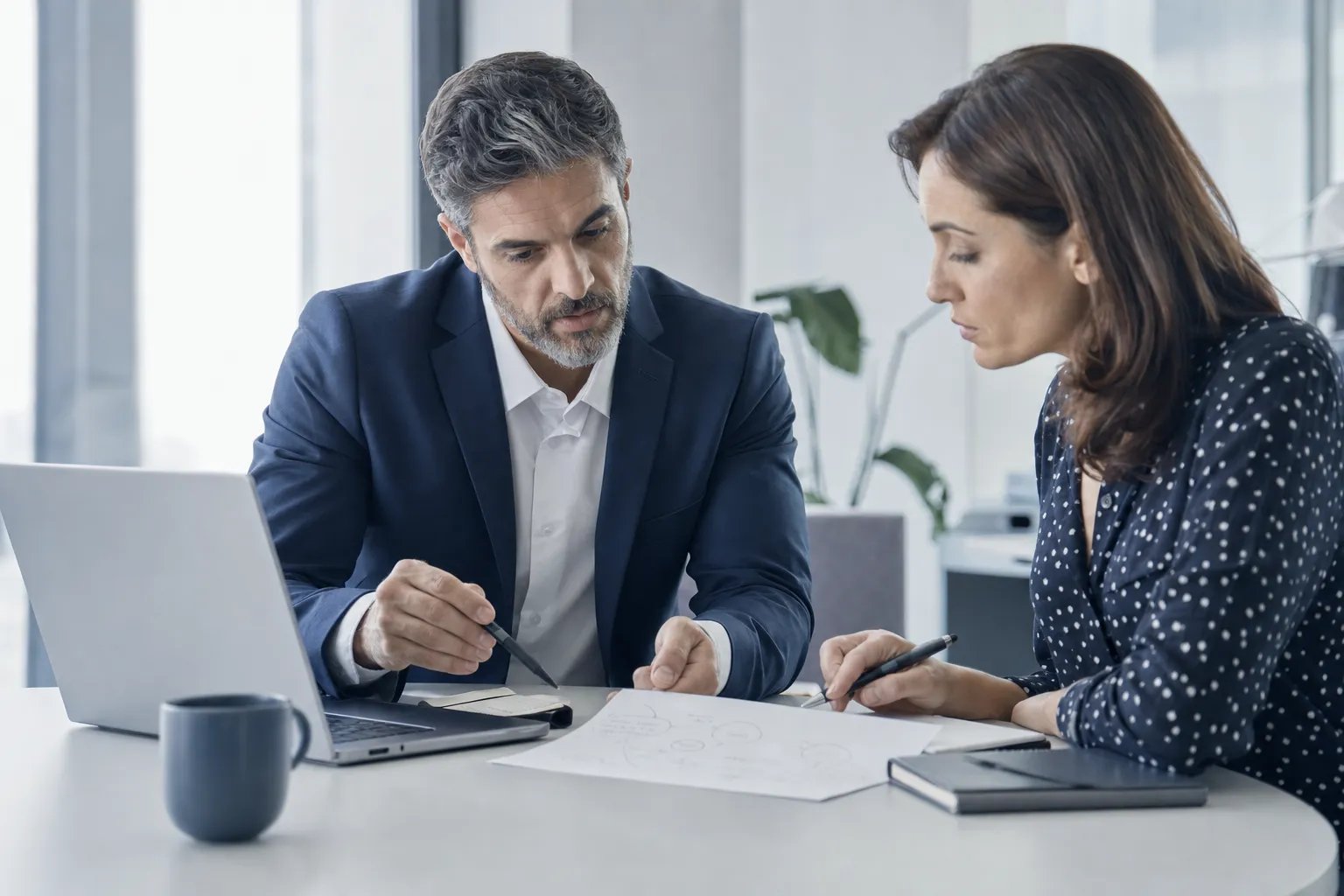 Two professionals in an advisory strategy discussion.